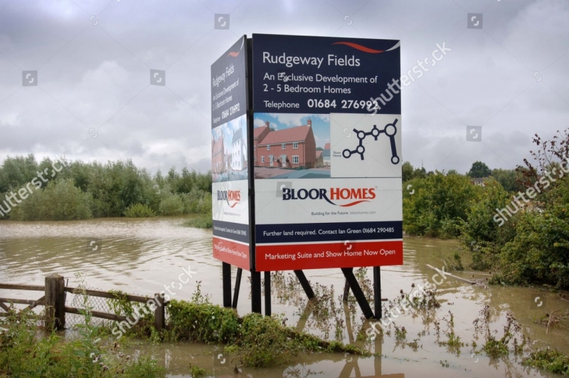 a-sign-advertising-a-new-housing-development-in-a-flood-plain-tewkesbury