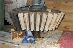 Wooden teeth in a cast iron wheel for a water mill.