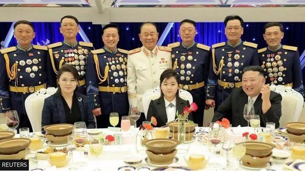 Kim at breakfast with Medals R Us behind him