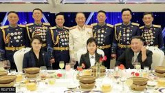 Kim at breakfast with Medals R Us behind him