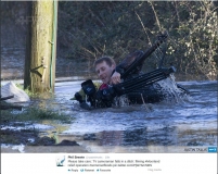 Cameraman falls in flood